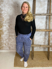 Stretch-housut reilulla mitoituksella, paljettikoristeiset lahkeet, korkea kuminauhavyötärö, taskut, kapeneva lahje