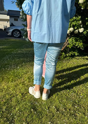 Kiiltäväpintaiset stretch-housut, kuminauhavyötärö, taskut edessä ja takana, joustavat, sopii kokoihin 38–44, viskoosisekoite.