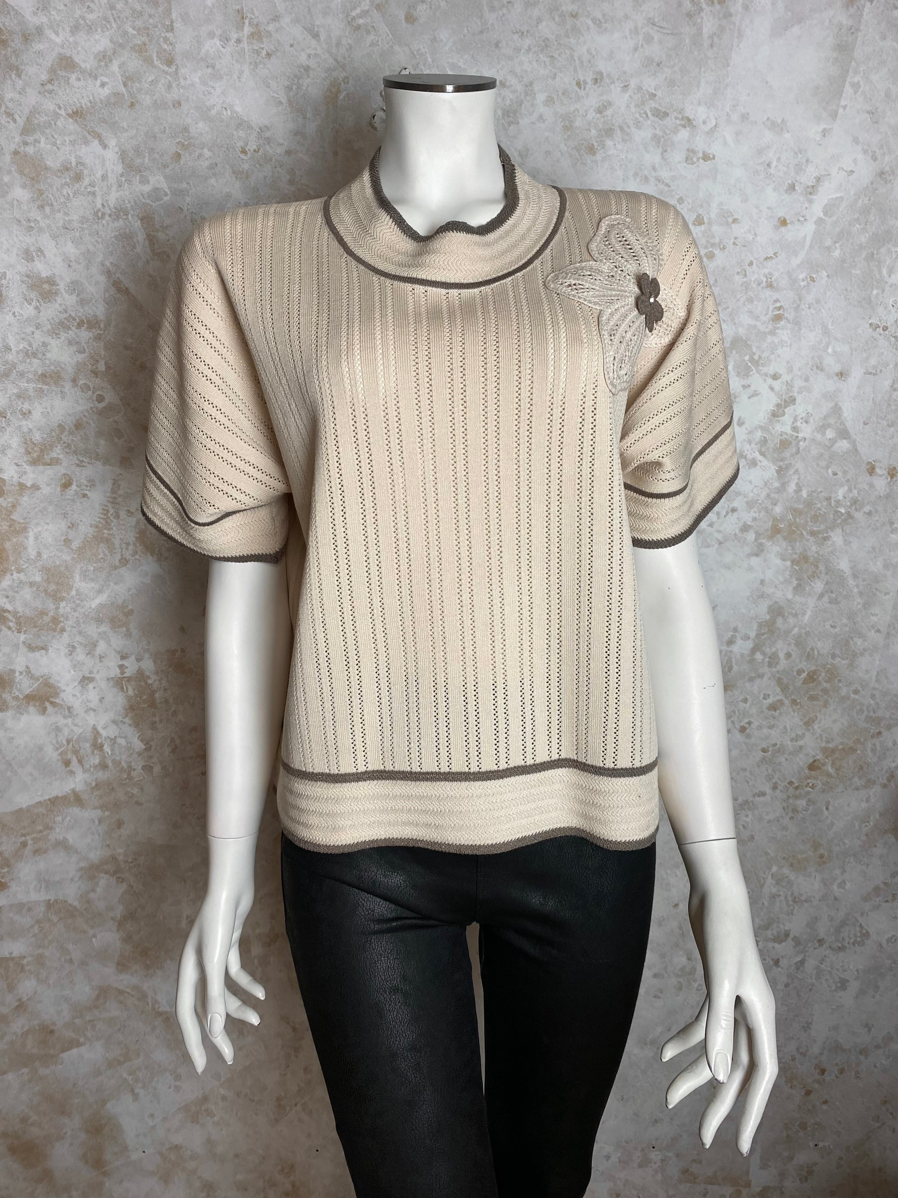 Naisten beige neule strassikukalla, paksu pehmeä materiaali, suora malli, pystykaulus, O-pääntie ja kimaltavat resorit