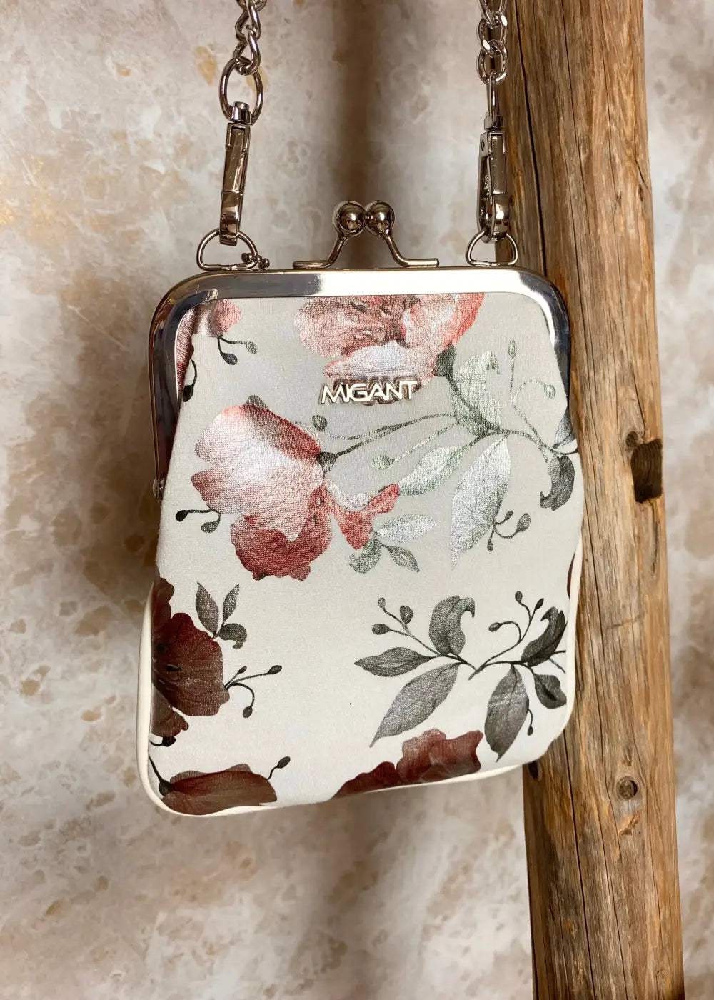 Kukkakuvioinen olkalaukku ketju- ja säädettävällä hihnalla, klipsikiinnitys ja hopeansävyiset yksityiskohdat