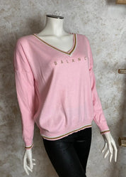 Pehmeä neule V-pääntiellä, glitter-painatuksella ja alaspäin kapenevalla mallilla, laskettu olkalinja ja kultakirjailut resoreissa