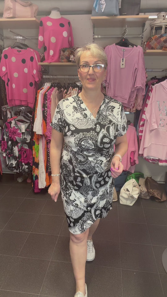 Musta paisley-kuvioinen valekietaisumekko V-pääntiellä, levenevä helma ja lyhyet hihat, kevyt joustava materiaali