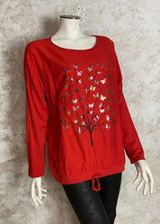 Värikäs elämänpuu-paita, jossa pitkät hihat, kimaltava etukuvio, laskettu olkalinja ja säädettävä helma.