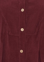 Naisellinen samettipaitamekko napituksella ja kauluksella, leveä helma, laskokset ja taskut – elegantti valinta arkeen ja juhlaan.