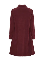 Naisellinen samettipaitamekko napituksella ja kauluksella, leveä helma, laskokset ja taskut – elegantti valinta arkeen ja juhlaan.